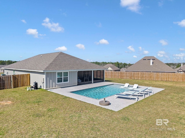 view of swimming pool with a sunroom, a fenced backyard, and a yard