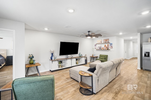 living room featuring ceiling fan, light wood-type flooring, and recessed lighting