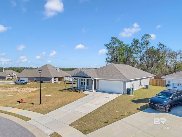 single story home featuring a front yard, driveway, an attached garage, and fence