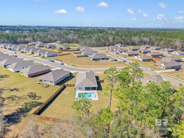 aerial view featuring a residential view and a wooded view