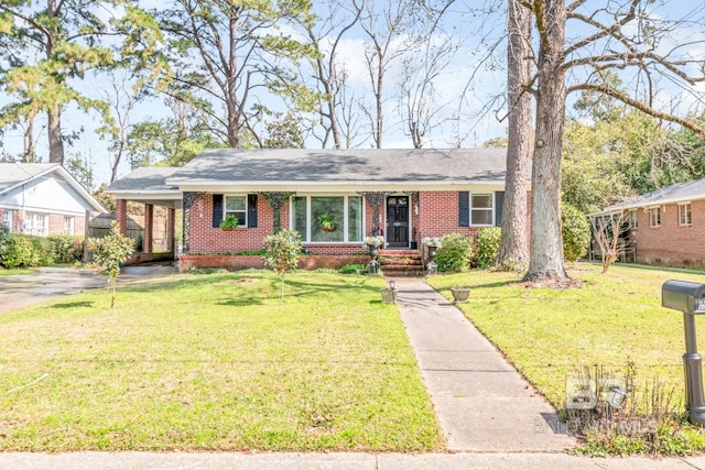 single story home featuring an attached carport, a front lawn, and brick siding