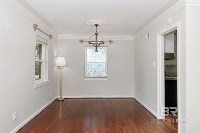 unfurnished dining area with a chandelier, baseboards, wood finished floors, and ornamental molding