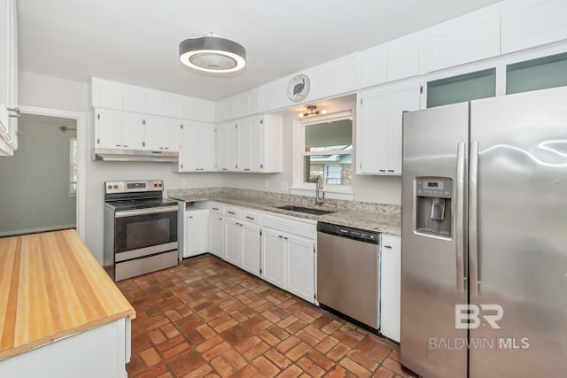 kitchen featuring a sink, white cabinets, under cabinet range hood, and stainless steel appliances