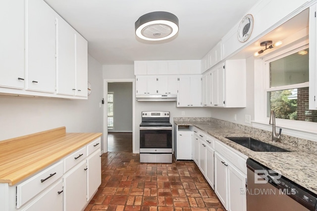 kitchen with under cabinet range hood, a wealth of natural light, appliances with stainless steel finishes, and a sink