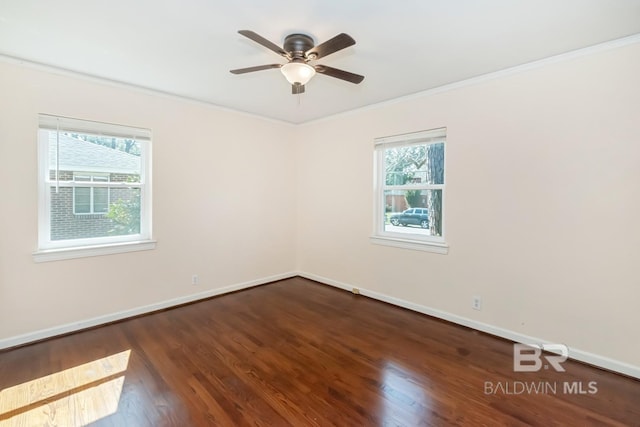 unfurnished room with a ceiling fan, crown molding, baseboards, and wood finished floors