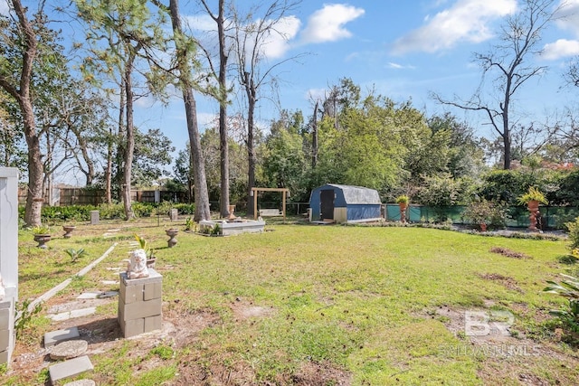 view of yard featuring a fenced backyard, a storage shed, and an outdoor structure