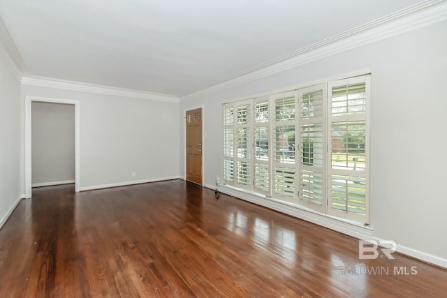 unfurnished room with wood finished floors, baseboards, and ornamental molding