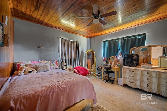 bedroom featuring carpet, wood ceiling, ornamental molding, and a ceiling fan