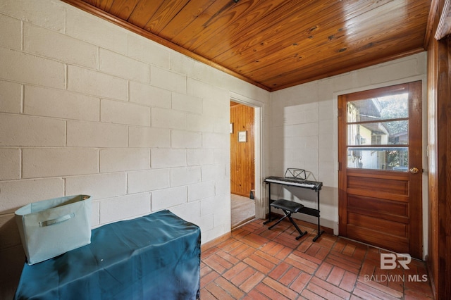 interior space featuring wood ceiling and brick floor