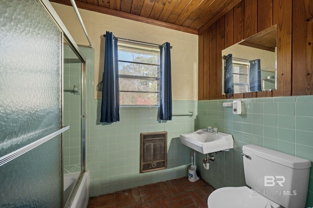 bathroom with toilet, a sink, tile walls, enclosed tub / shower combo, and wood ceiling