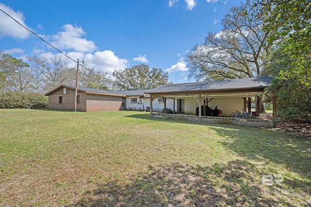 rear view of property with a yard