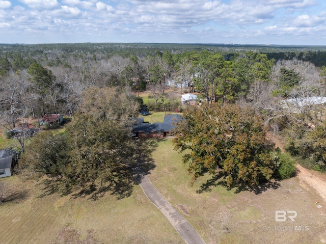 drone / aerial view with a wooded view