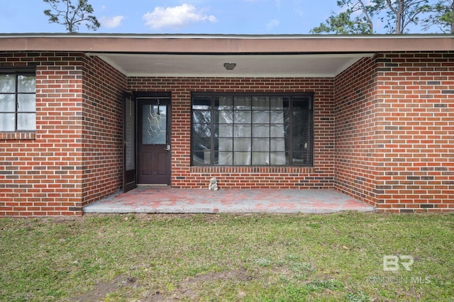 property entrance with brick siding