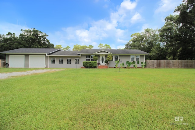 single story home with a front yard and a garage