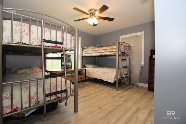 bedroom with ceiling fan and light hardwood / wood-style floors