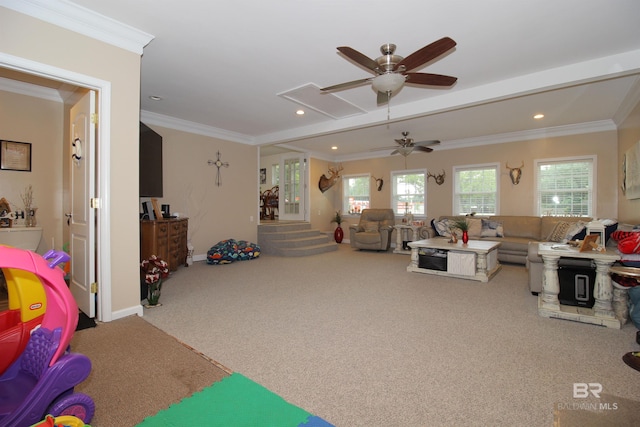 carpeted living room featuring crown molding, ceiling fan, and a healthy amount of sunlight