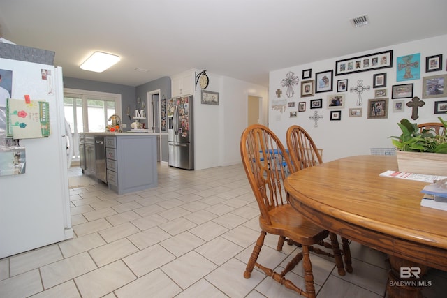 dining area featuring light tile patterned floors