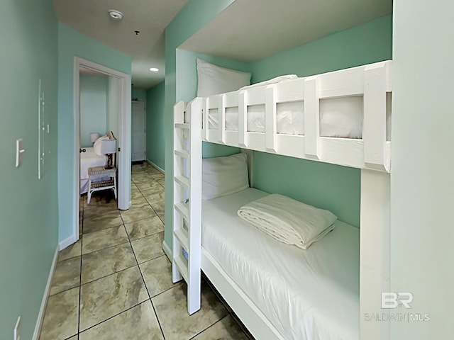 tiled bedroom featuring baseboards and recessed lighting