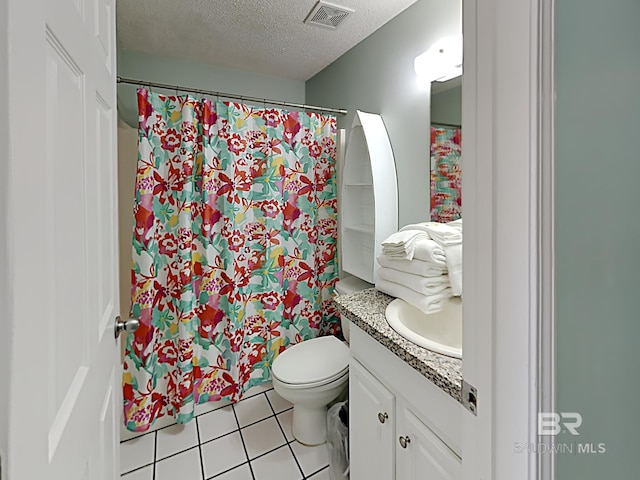full bath featuring tile patterned floors, toilet, vanity, a textured ceiling, and visible vents