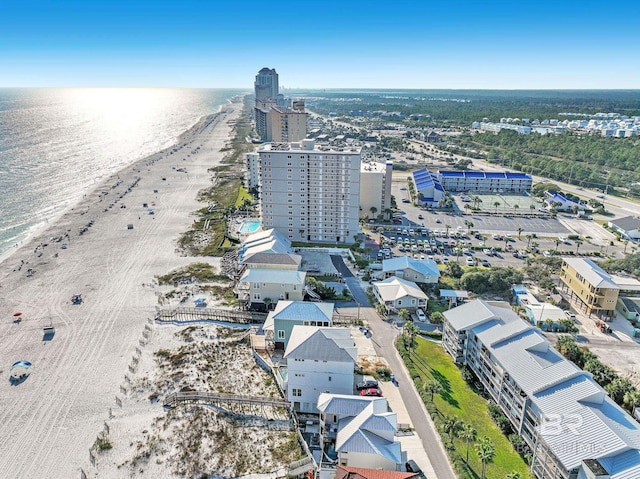 birds eye view of property featuring a water view and a beach view