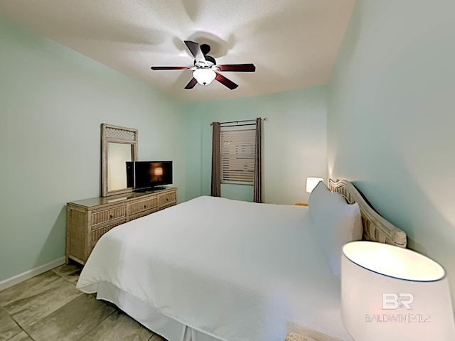 bedroom with baseboards and ceiling fan
