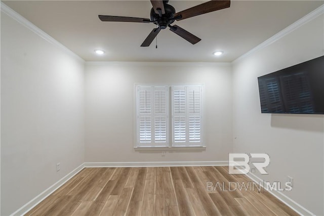 spare room featuring hardwood / wood-style floors, ceiling fan, and crown molding