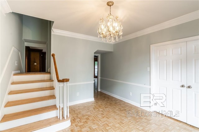 stairway with parquet floors, a chandelier, and ornamental molding