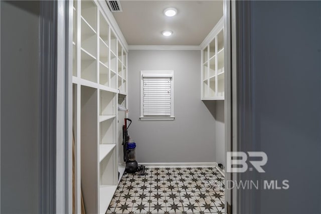 clothes washing area featuring crown molding