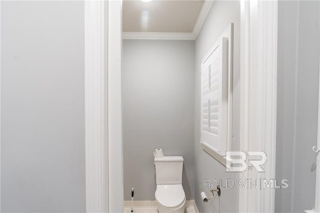 bathroom featuring ornamental molding and toilet