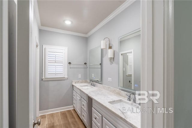 bathroom with hardwood / wood-style floors, vanity, and crown molding