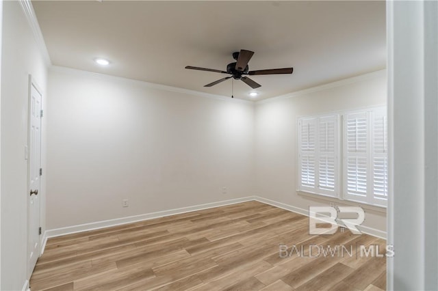 spare room featuring ceiling fan, light wood-type flooring, and crown molding