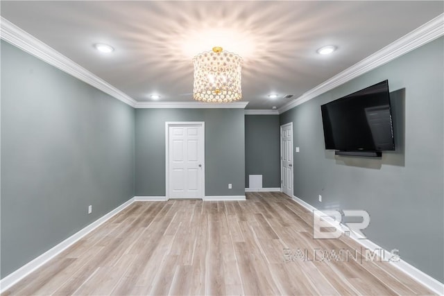 unfurnished room with crown molding, a chandelier, and light wood-type flooring