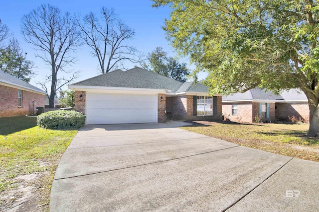 ranch-style house with driveway, a garage, a shingled roof, a front lawn, and brick siding