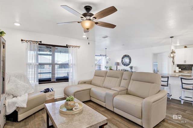 living room with ceiling fan and hardwood / wood-style floors