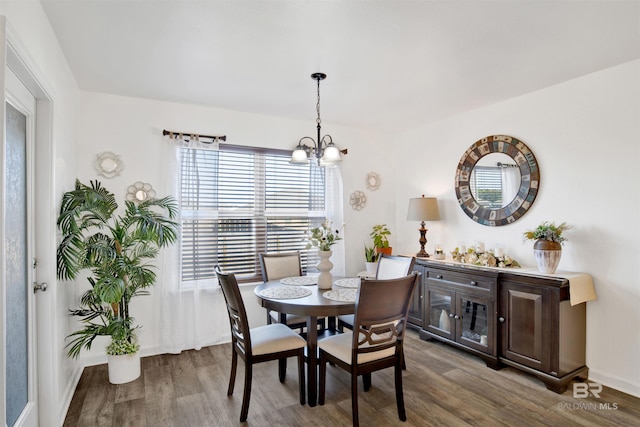 dining space with wood-type flooring and a chandelier