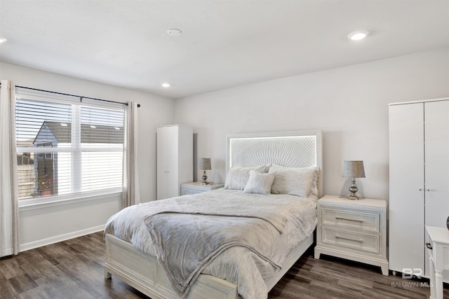 bedroom with dark hardwood / wood-style flooring