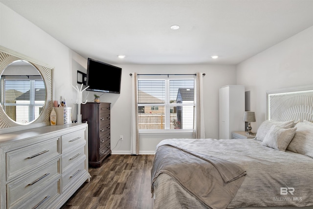 bedroom with dark hardwood / wood-style floors