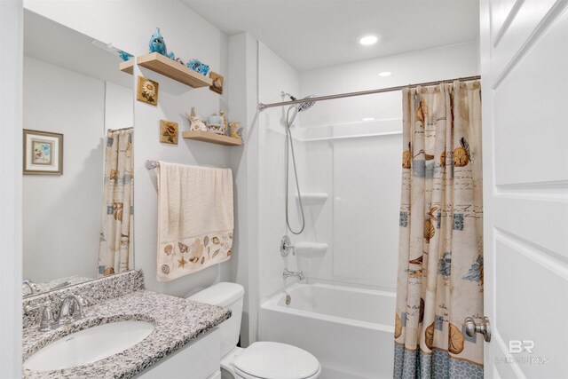 full bathroom with vanity, shower / bath combo, and toilet