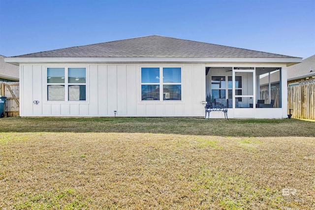 back of house featuring a sunroom and a yard