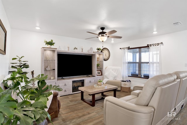 living room with hardwood / wood-style floors and ceiling fan