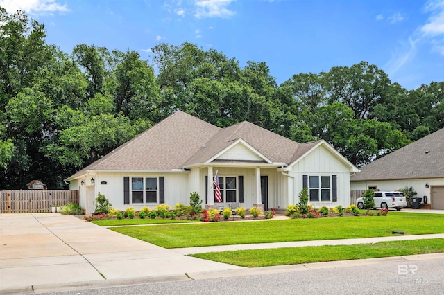 316 Nandina Loop, Fairhope, AL 36532 - view of front of house with board and batten siding, driveway, a gate, and roof with shingles