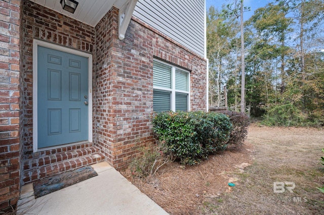 property entrance with brick siding