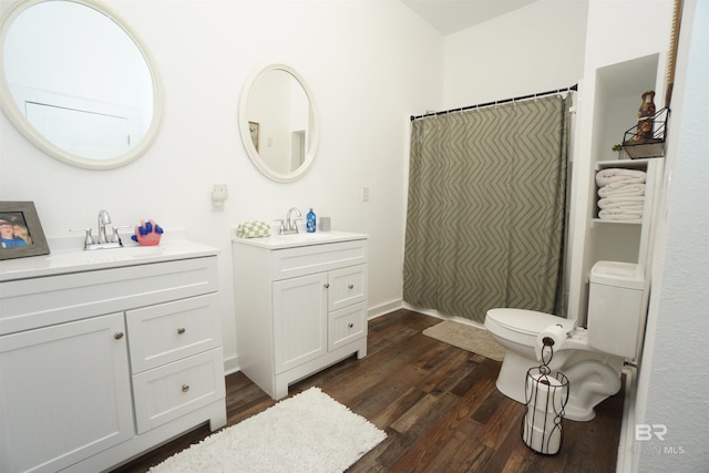 bathroom featuring hardwood / wood-style flooring, vanity, and walk in shower