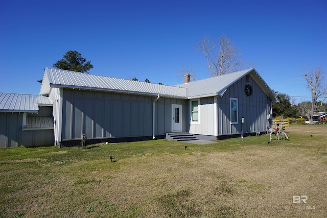 rear view of property featuring a yard