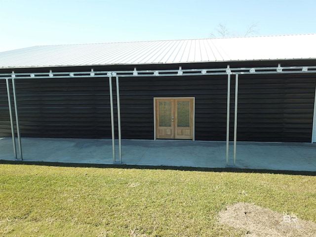 back of property featuring french doors and a yard