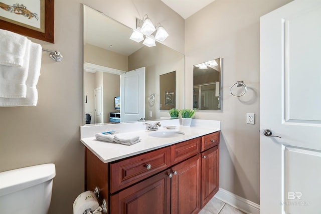 bathroom with tile patterned flooring, vanity, and toilet