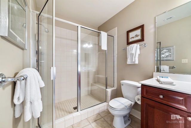 bathroom with vanity, tile patterned flooring, a shower with door, and toilet