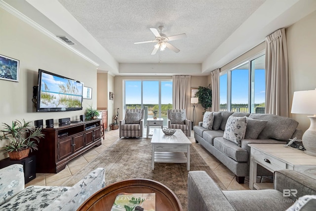 tiled living room with ceiling fan and a textured ceiling