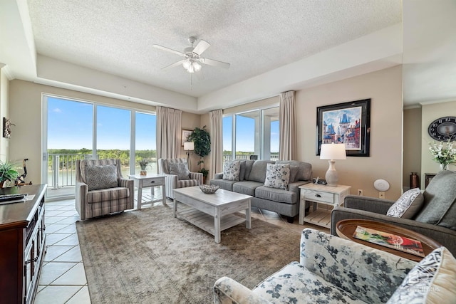 living room featuring light tile patterned floors, a textured ceiling, a wealth of natural light, and ceiling fan