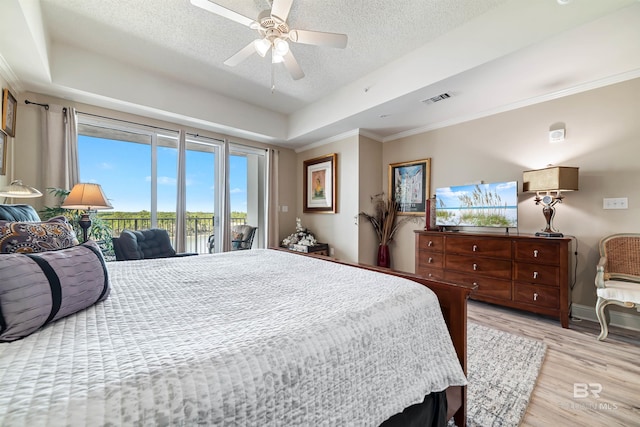 bedroom with crown molding, ceiling fan, light hardwood / wood-style floors, a textured ceiling, and access to outside